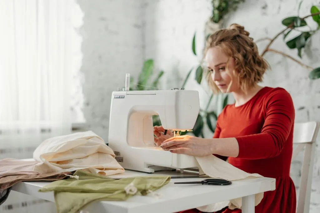 A woman sewing a wedding dress A woman sewing a wedding dress